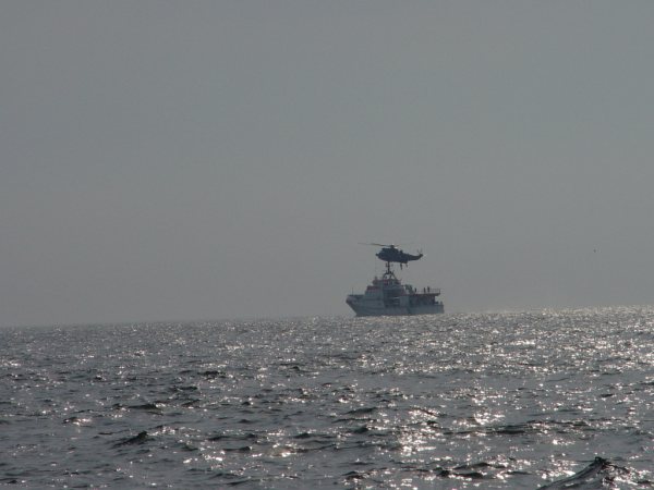 Der Seenotrettungskreuzer Hermann Marwede und ein Hubschrauber proben auf See die Übernahme von Personen.