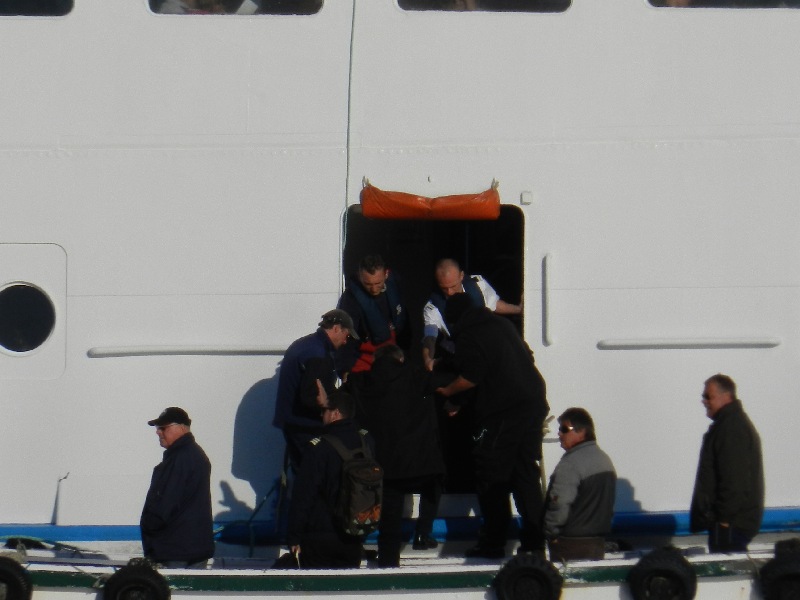 Das Passagierschiff Fair Lady auf der Helgoländer Reede wird zum letzten Mal in dieser Saison eingebootet, dazu liegt gerade das letzte Boot an der Helgoland-Pforte der Steuerbordseite.