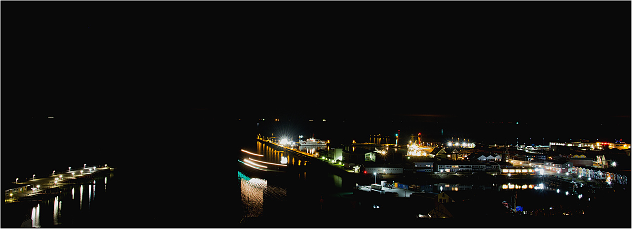 Der bei Nacht in den Scheibenhafen einlaufende Frachter.