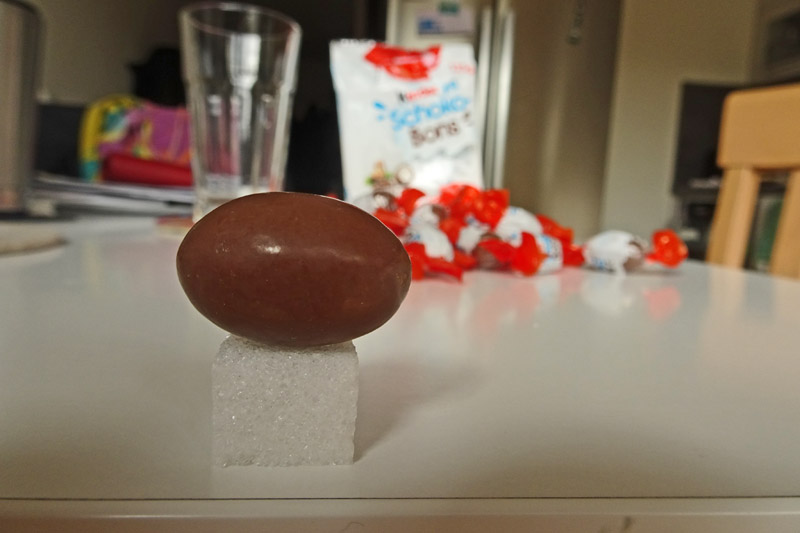 Ein Kinder Schokobon im Vergleich zu einem Zuckerwürfel.