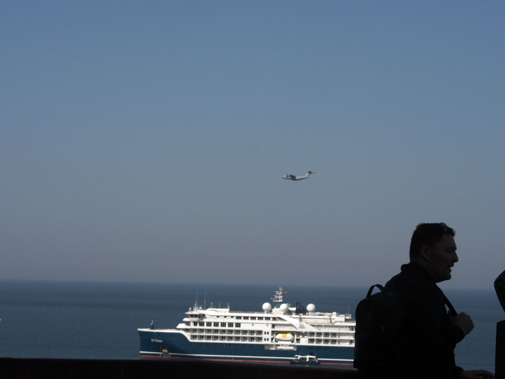 Kreuzfahrtschiff SH Diana ankert auf dem Fahrwasser vorm Schwimmbad auf Helgoland und wird von einer Airbus A400M &uuml;berflogen.